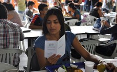 Estudante lê folheto distribuído pela equipe ReduSAL